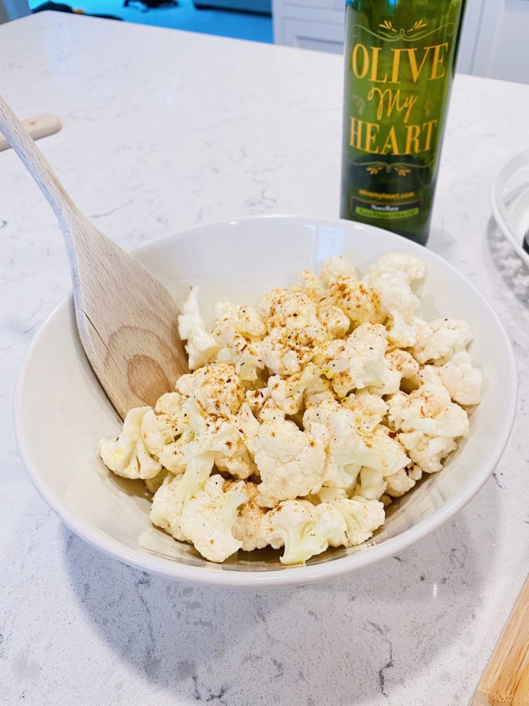 cheesy cauliflower bites in bowl seasoned