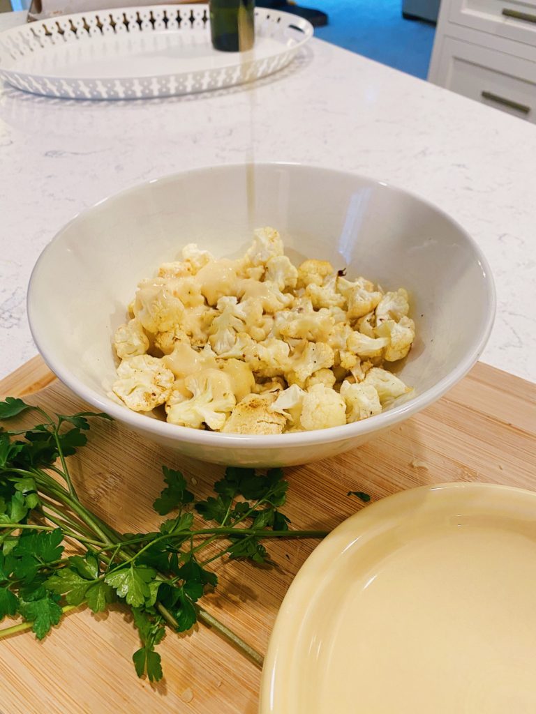 cheese sauce poured on cheesy cauliflower bites